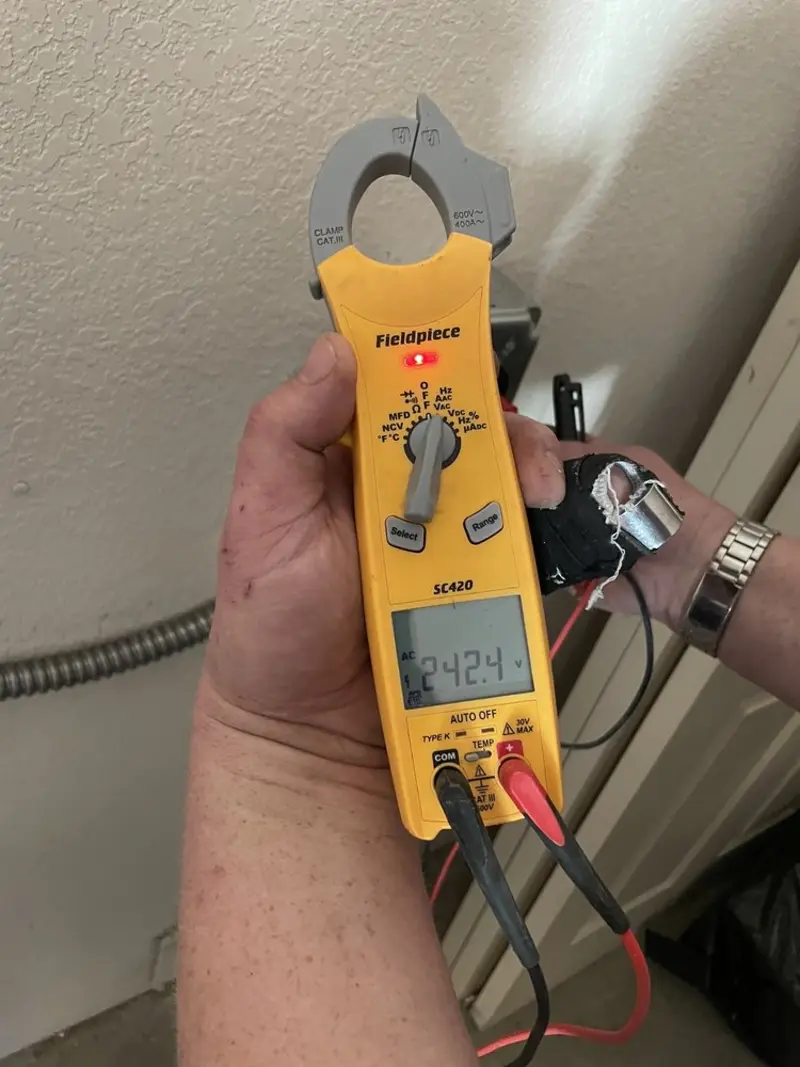Voltage testing with clamp meter during Whole House Surge Protector in Houston